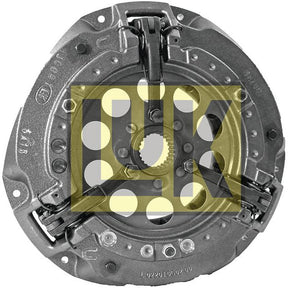 A circular metallic clutch pressure plate with a central opening and several evenly spaced holes, branded with the transparent "LK" logo, housed within a robust cast iron housing, such as the Clutch Cover Assembly - S.145231 by Sparex.