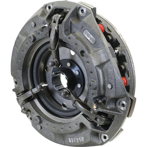 A close-up view of the Sparex S.40677 Clutch Cover Assembly, a heavy-duty metal mechanical part made from cast iron featuring intricate components such as springs and clamps, suggests it is an integral part of a larger machine or vehicle system.