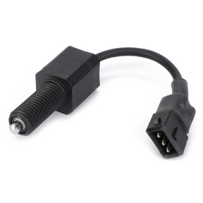 The AGCO Massey Ferguson Clutch Switch (3784055M1) features a black electrical connector with a cylindrical component on one end and a 3-pin rectangular connector on the other, connected by a short black cable. It is ideal for use with Massey Ferguson equipment.