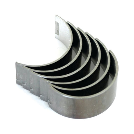 Close-up of five metal Conrod Bearing +0.010'' (0.25mm) sets by Sparex, marked with the durability reminiscent of International Harvester, stacked together in a semi-circular shape.