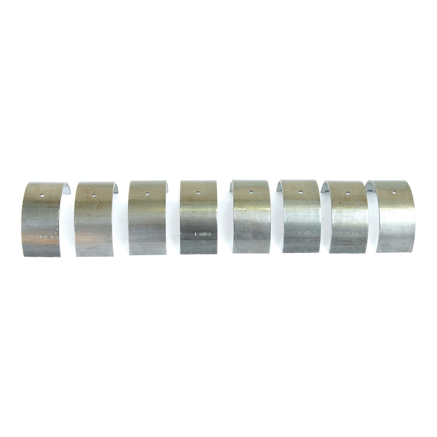 The Conrod Bearing +0.020'' (0.50mm) Set by Sparex, Part No. S.42500, consists of eight metal bearing shells arranged in a row, each featuring small notches and markings. These bearings are used in tractor parts from brands like Sparex or Massey Ferguson to reduce friction and wear on rotating components.