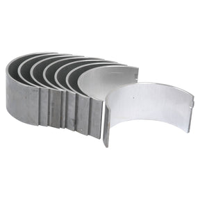 The Conrod Bearing Std. Set by Sparex (Sparex Part No.S.42922) is a set of seven metallic semi-circular bearing shells arranged in a staggered stack, designed to be compatible with Landini, Massey Ferguson, and Perkins engines.