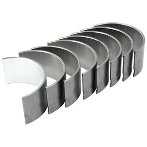 A set of seven Conrod Bearing Std. Bearings from Sparex, arranged in a neat row on a white background, reminiscent of those used in David Brown tractors.
