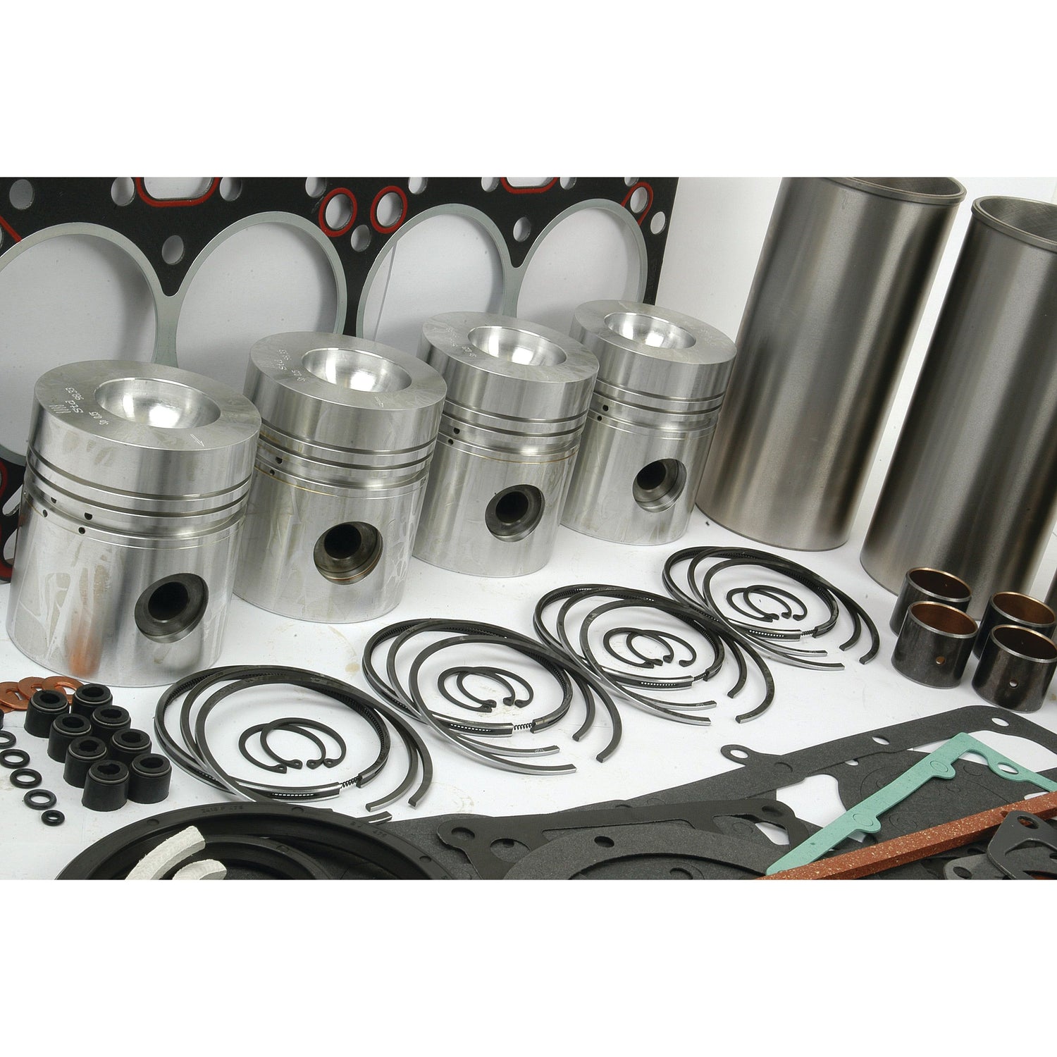 Assorted engine parts, such as pistons, rings, gaskets, and cylindrical components from the Sparex Engine Overhaul Kit without Valve Train (Finished) - S.41903 for the Perkins A4.212 Engine Model, arranged on a white background.