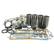 A neatly arranged collection of automotive engine parts, including pistons, gaskets, cylinders, and various seals, all designed to fit seamlessly into the Sparex Engine Overhaul Kit with Valve Train (Finished) - S.66816 for Ford vehicles.
