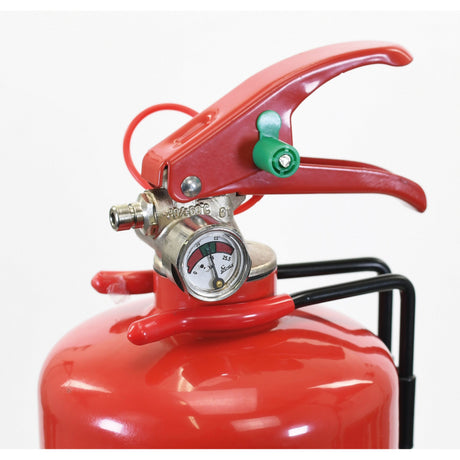 Close-up of the top part of the Sparex Fire Extinguisher - ABE Dry Powder, Capacity: 1kg - S.6999, showing the pressure gauge, handle, and safety pin. The gauge displays the pressure level of this dry powder, ozone-friendly device.