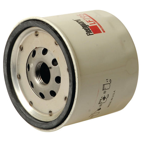A Sparex white cylindrical Spin On oil filter (LF795) with metal components and a central threaded hole, featuring printed text and diagrams on its surface (Sparex Part No. S.61803).