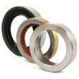 Close-up of three mechanical seals from the Half Shaft Repair Kit (Sparex Part No. S.42078) aligned side by side, showcasing varied materials and colors: one black, one with a copper-colored interior, and one silver. These high-quality Sparex components are perfect for Massey Ferguson machinery.