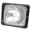 Close-up of a square Sparex Head Light (Halogen) RH & LH, RH Dip, 12/24V - S.56021 with a clear lens and black frame, showcasing an intricate reflector design inside. Featuring a Hella Bulb for superior illumination, two screws are visible on the sides of the frame.