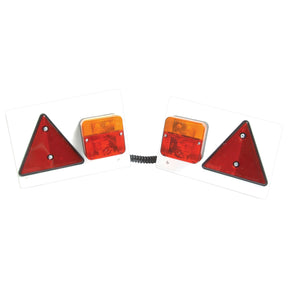 The Sparex Halogen Lighting Set, S.14842, includes two connected trailer lights mounted on white plates, each featuring a red triangle reflector, a red square light, and an orange halogen light source. The setup boasts a 14-meter cable length with a maximum extension of 1.5 meters and is equipped with an S.3400 Male 7 Pin Plug for easy connection to most trailers.