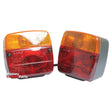 Two rectangular red and amber Massey Tractor Parts taillights from the Sparex brand, featuring the Lighting Set (Halogen), Function: 4, Brake / Tail / Indicator / Number Plate, 12V - S.51745 model, are positioned side by side and facing forward. Equipped with reliable Halogen bulbs, these taillights include a 7 Pin Plug for easy installation and compatibility with Sparex components for added convenience.