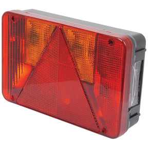 The Sparex Rear Combination Light (Halogen) is a rectangular unit with red and amber sections, featuring a red reflective triangle in the center. This 12V lamp includes functions for Brake, Tail, Indicator, and Number Plate lighting, ensuring enhanced visibility on the road.