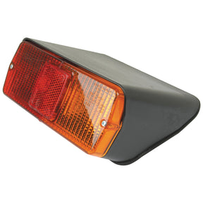 The Sparex Rear Combination Light (Halogen) S.56286 is a triangular vehicle tail light assembly featuring red and amber sections, equipped with a 12V Halogen light source for brake, tail, and indicator functions. It includes two mounting screws for installation.