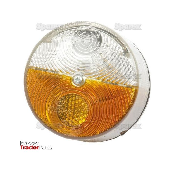 The Front Combination Light (Halogen) S.56134 sold by Massey Tractor Parts, featuring both clear and amber sections and a central screw design for easy installation, enhances visibility with Hella-inspired halogen technology. This versatile light is compatible with 12/24V systems and suitable for both right-hand and left-hand applications.