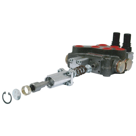 A disassembled Sparex - Detent Kit (Sparex Part No. S.24450) designed for 3/8'' and 1/2'' Monoblock Valves, consisting of various metal components and a spring, featuring two black cylindrical connectors and multiple red circular ports.