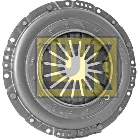 A circular metal automotive component with multiple bolts along the edge and a central opening, featuring the print of a yellow and gray Sparex logo overlaid with abstract patterns. This is the Clutch Cover Assembly - S.145271.