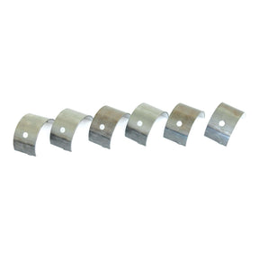 Six metallic bearing shells with a single hole in each, arranged in a row on a white background, compatible with Massey Ferguson and Landini equipment. The product is the Main Bearing +0.010'' (0.25mm) Set under Sparex Part No.S.42363 from the brand Sparex.