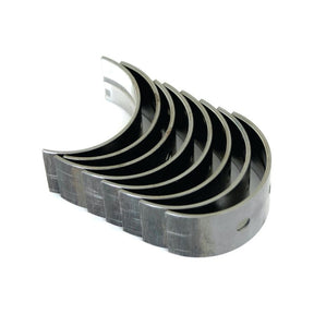 A set of seven curved metal pieces, likely the Sparex Main Bearing +0.010'' (0.25mm) (Set) | Sparex Part No.S.57529, arranged in a staggered formation against a white background.