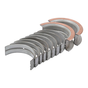 A set of ten semi-circular metal main bearings, compatible with Ford New Holland, arranged in a row on a white background. These are part of the Main Bearing +0.010'' (0.25mm) (Set), Sparex Part No.S.65224 by Sparex.