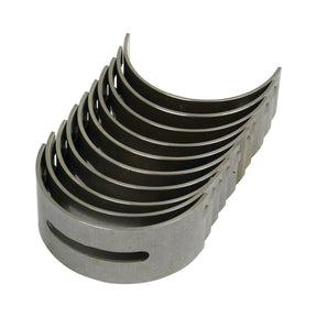 The Main Bearing Std. (Set) by Sparex, Part No. S.40339, is a set of ten metal semicircular bearing shells stacked together, typically used as main bearings in internal combustion engines, suitable for Perkins Build List or Massey Ferguson machinery.
