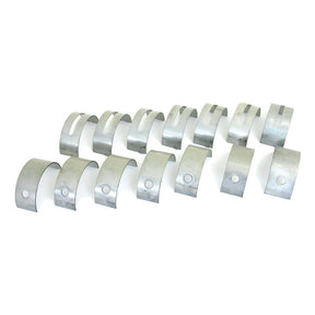 A set of 16 silver main bearings, aligned in two rows and featuring a hole on one end, compatible with Massey Ferguson models. This product is the Main Bearing Std. (Set) by Sparex, Part No.S.42118.