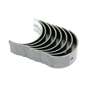 A set of six semi-circular metal rod bearings, ideal for internal combustion engines, arranged in a stack. These bearings are compatible with Case IH machinery and meet David Brown standards for reliability and performance. The product is named Main Bearing Std. (Set) with Sparex Part No.S.57526 from the Sparex brand.