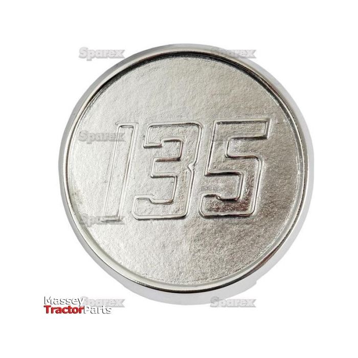 The Sparex Medallion for Massey Ferguson 135 (Part No. S.43793) is a silver, circular piece featuring the number "135" embossed on it, with the words "Massey Ferguson Tractor Parts" appearing in the lower left corner and highlighted with a sleek chrome finish.