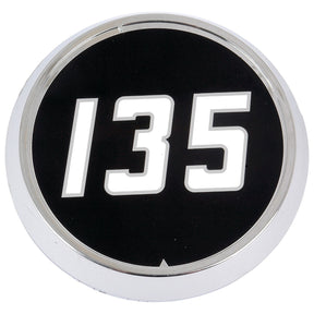 Round black plastic medallion with white number "135" centered, surrounded by silver trim - Medallion for Massey Ferguson 135, Sparex Part No.S.41217.