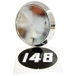 A shiny, round metal object next to a black circular sticker with white numbers "148" resembles the Medallion - Massey Ferguson 148 by Sparex, Part No.S.41642.