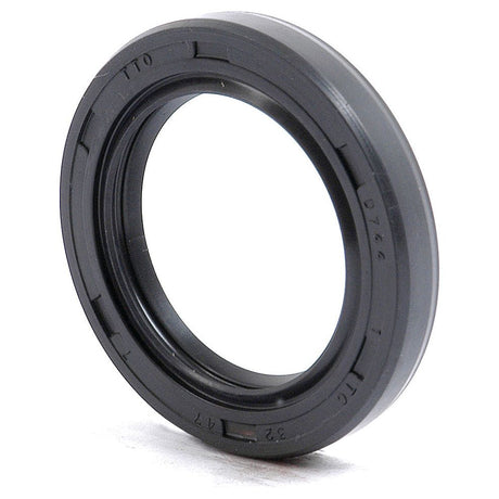 A Sparex Metric Rotary Shaft Seal (Part No. S.50256), black and rubber, with a circular shape and 32 x 47 x 7mm dimensions, featuring inscriptions on its outer edge, rests upright on a flat surface. The seal boasts a durable double lip design.