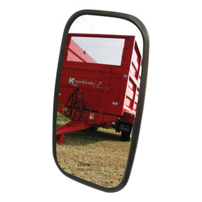 Reflected in a *Sparex Mirror Head - Rectangular, Flat, 320 x 180mm, RH & LH - S.6224*, a red K-Two Roadeo trailer shows its rear section and attached hydraulic hoses against the backdrop of a grassy field.