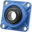 The NTN SNR Four-Bolt Flanged Unit (ESF207T20) - S.138538 by Sparex is a blue square flanged bearing unit featuring a round black bearing in the center. It is suitable for various applications and has four mounting holes, one at each corner. The letters "SNR" are inscribed on the top. For more manufacturing information, please refer to the provided documentation.