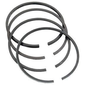 A set of five circular piston rings, finished in black with durable chrome plating, arranged in a staggered stack. Designed for optimum performance with Case IH machinery, these metal rings are available under the name Sparex Piston Ring Std., part number S.57508.