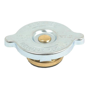 The S.57262 Radiator Cap by Sparex is a round silver cap with a central gold mechanism, designed to fit International Harvester models. It features engraved text, "REMOVE SLOWLY," along with other specifications.
