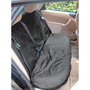 The rear seat of a car is adorned with the Sparex Rear Van Seat Cover - Car & Van - Universal Fit - S.71864, featuring a sleek black, waterproof design. The car door stands open, showcasing the beige interior and a fastened safety belt.