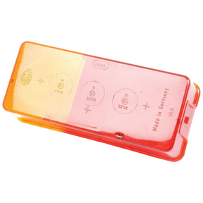 A rectangular plastic automotive lens cover, half red, half yellow, with markings and text indicating it is a Sparex Replacement Lens (fits S.56074) made in Germany.