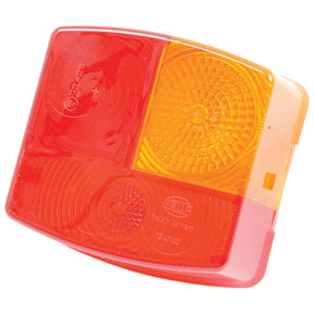 Close-up of a rectangular red and orange plastic vehicle tail light with a HELLA logo and Hella E Approved marking, featuring manufacturing details etched into the surface. This Replacement Lens (Sparex Part No. S.56156) is compatible with Case IH models and is available as part of the Sparex line, fitting S.56082.