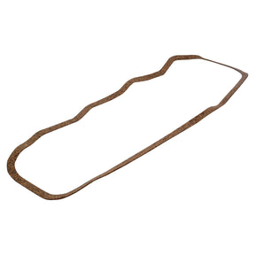 A Rocker Cover Gasket - 4 Cyl. (Sparex Part No. S.57686) by Sparex, featuring an irregular shape and made from a brown cork-like material, is suitable for the IH Case Engine Model.
