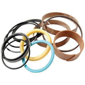 Assorted circular rubber and metal rings in various sizes and colors, including black, brown, yellow, and blue, scattered on a white background. Perfect for your Massey Ferguson maintenance needs or to add to your Sparex Seal Kit (Part No. S.42262).
