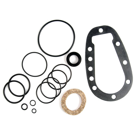 An assortment of variously sized rubber O-rings and gaskets, including one large uniquely shaped gasket with holes around its perimeter, and a felt ring, essential for Ford / New Holland power steering gear assembly repairs, arranged against a white background. This Seal Kit (Power Steering Gear Assembly) by Sparex (Part No.S.66376) ensures you have all the components you need for an effective repair.