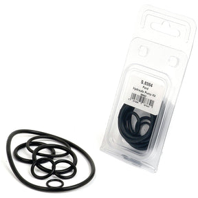 A Hydraulic Pump Seal Kit (Agripak 7 pcs.) by Sparex, featuring black O-rings, is shown. Some of the O-rings from this Sparex Part No.S.8384 seal kit are laid out beside the transparent packaging.