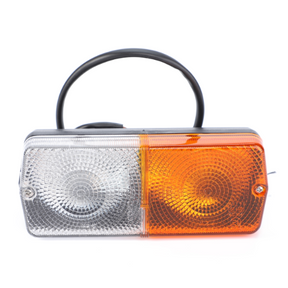 The AGCO Massey Ferguson - Sidelight R/H - 1678990M91 features a black base with a clear lens on the left and an amber lens on the right, complete with an attached black cable. It's ideal for 100 Series or Massey Ferguson tractors.