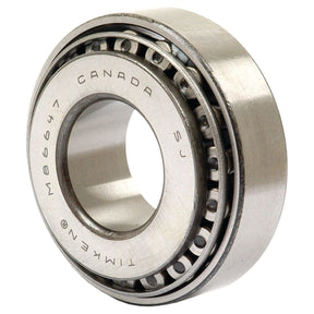 A close-up shot of a metal ball bearing with the text "CANADA M86647 TIMKEN" engraved on its surface. The Sparex Taper Roller Bearing (86610/86647) - S.33265, suitable for various applications, features an inner and outer ring with a series of small balls in between.