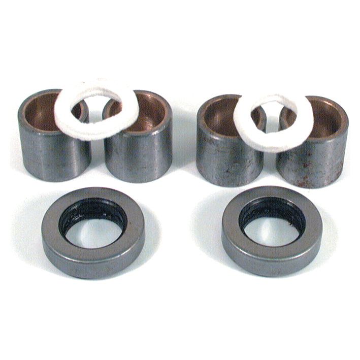Two pairs of cylindrical metal components with white bushings, along with two circular black and silver rings, all arranged on a white surface. This set belongs to the Spindle Repair Kit from Sparex (Part No. S.42040) for Massey Ferguson, ensuring durable and efficient maintenance.