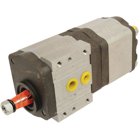 Close-up of the Tandem Hydraulic Pump - S.42172 by Sparex, featuring a metal casing, multiple ports, and a red wire connected at the end. This industrial-grade pump has a rectangular shape, making it ideal for heavy-duty applications.