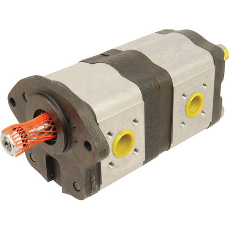 A close-up of the Sparex Tandem Hydraulic Pump - S.43590 with a metallic casing and yellow ports. The output shaft, designed for clockwise pump rotation, is covered with red protective netting.