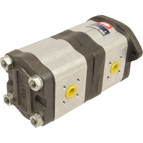 The Sparex Tandem Hydraulic Pump (S.43590) is a metal hydraulic pump with two sections, featuring four bolts on each end and yellow circular ports on the sides, designed for clockwise rotation.