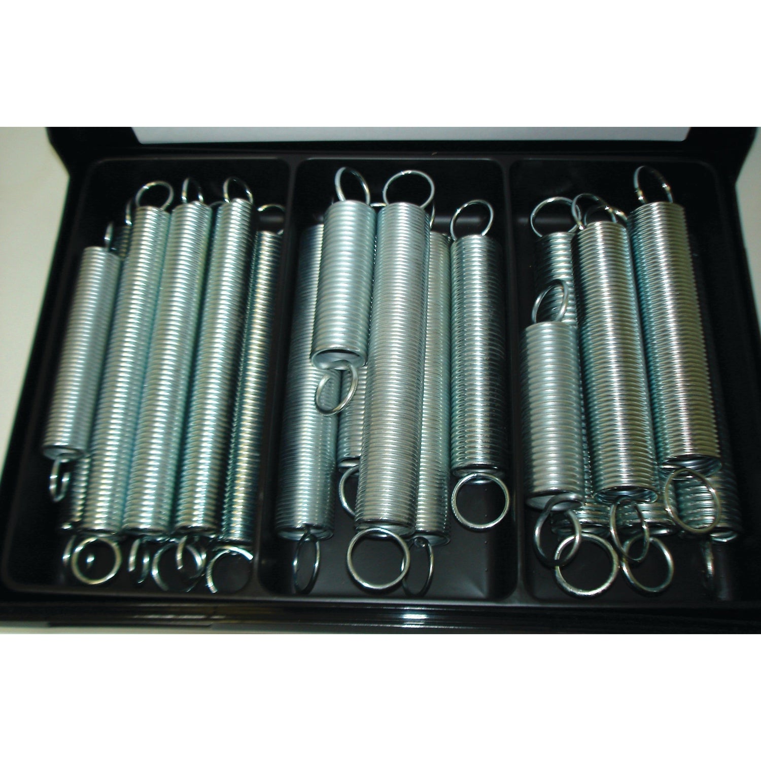 The Sparex Tension Springs (20 pcs. Compak | Sparex Part No.S.25712), neatly arranged in three compartments of a black plastic container, feature varying wire diameters.
