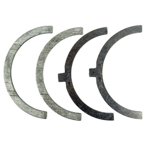 Four semi-circular thrust washers from the Thrust Bearings Set +0.25mm (Sparex Part No. S.58943) are arranged in a row against a white background.