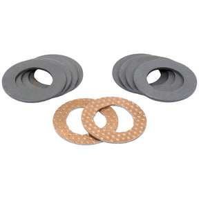 Two stacks of round grey metal washers are arranged neatly, with two perforated brown washers positioned prominently in front. This assembly includes components ideal for an Axle Spindle and resembles those found in the Sparex Thrust Washer Kit - Axle Spindle (Sparex Part No.S.43292).